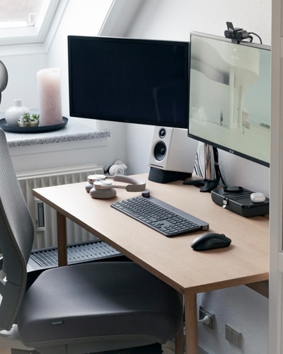 Brown wooden table in the black tablet computer monitors
